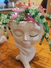 Elegant face planter with pink and green beaded plant