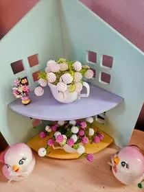 Miniature pastel beaded flowers in a dollhouse room